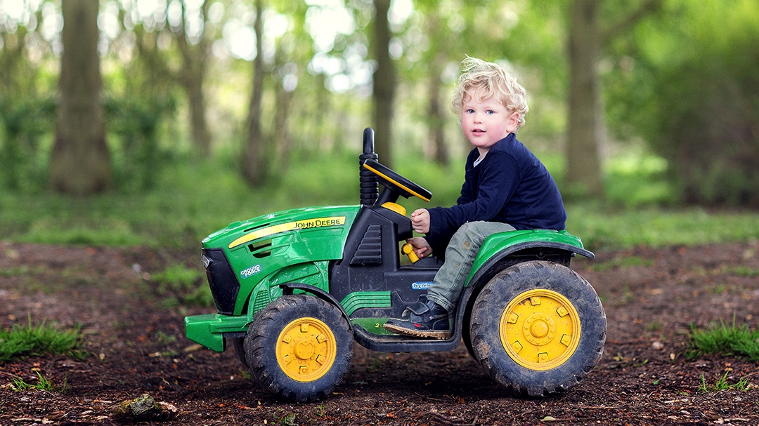 boy photographed at home in Newmarket on his toy tractor
