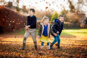 children throwing leaves