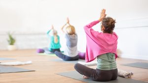 Three ladies practising yoga during a commercial photoshoot for Yoga At The Barn in Bourne, Cambridgeshire