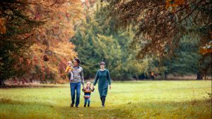 parents and children enjoying a stroll through Wandlebury Country Park during a photoshoot