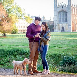 couple with their dog on the backs by Kings College Cambridge