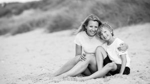mother and son relaxing during a family photo shoot at Brancaster beach in Norfolk
