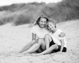 mother and son relaxing on the Norfolk coast during a family photo shoot