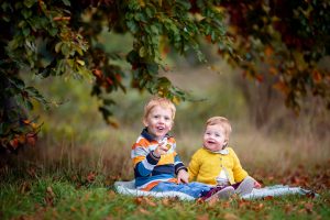 children photographed in the Autumn leaves in Cambridgeshire