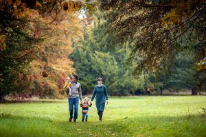 family walking through wandlebury country park during a mini shoot