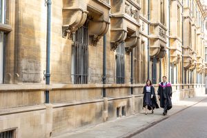 Graduating students on Trinity street Cambridge during a photoshoot