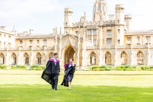 Graduating students on the lawn in front of St Johns college Cambridge during a photoshoot