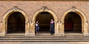 Cambridge students in graduation robes during a photoshoot at Trinity college