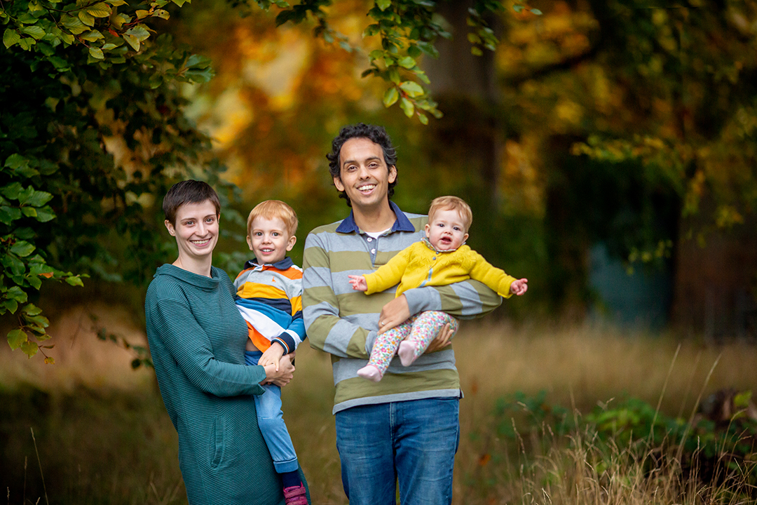 smiling family in an autumn portrait by cambridge photographer louisa french